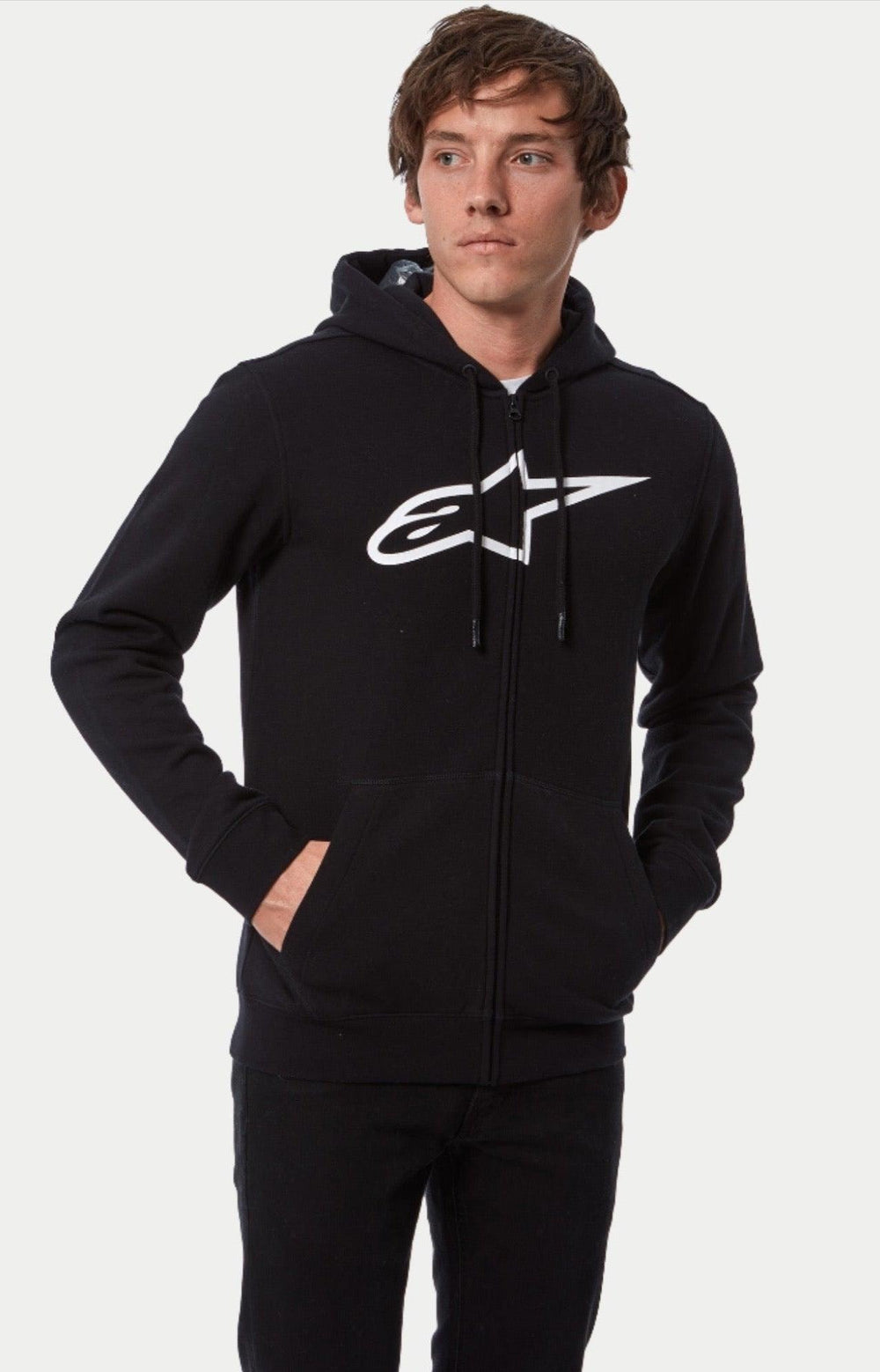 Alpinestars Ageless Zip V3 Hoodie, Full-zip hooded sweatshirt, Black with large white Astars chest logo, casual motorsport streetwear worn by a model, features drawstring hood and front pockets