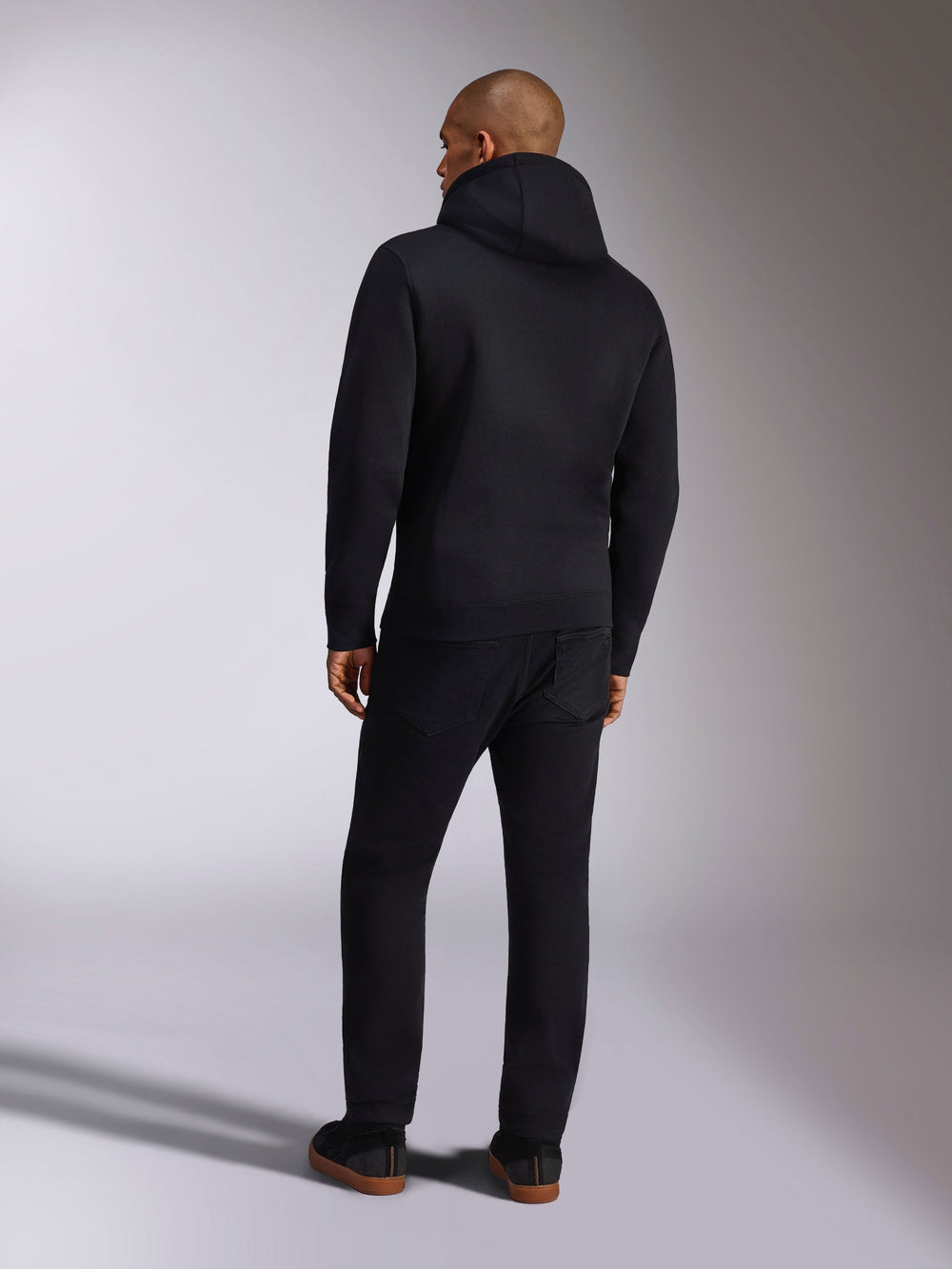 Alpinestars Ellipsoid Hoodie, casual sportswear, solid black hooded pullover fleece, back view, features long sleeves and ribbed hem, paired with black pants, modern motorsport-inspired design