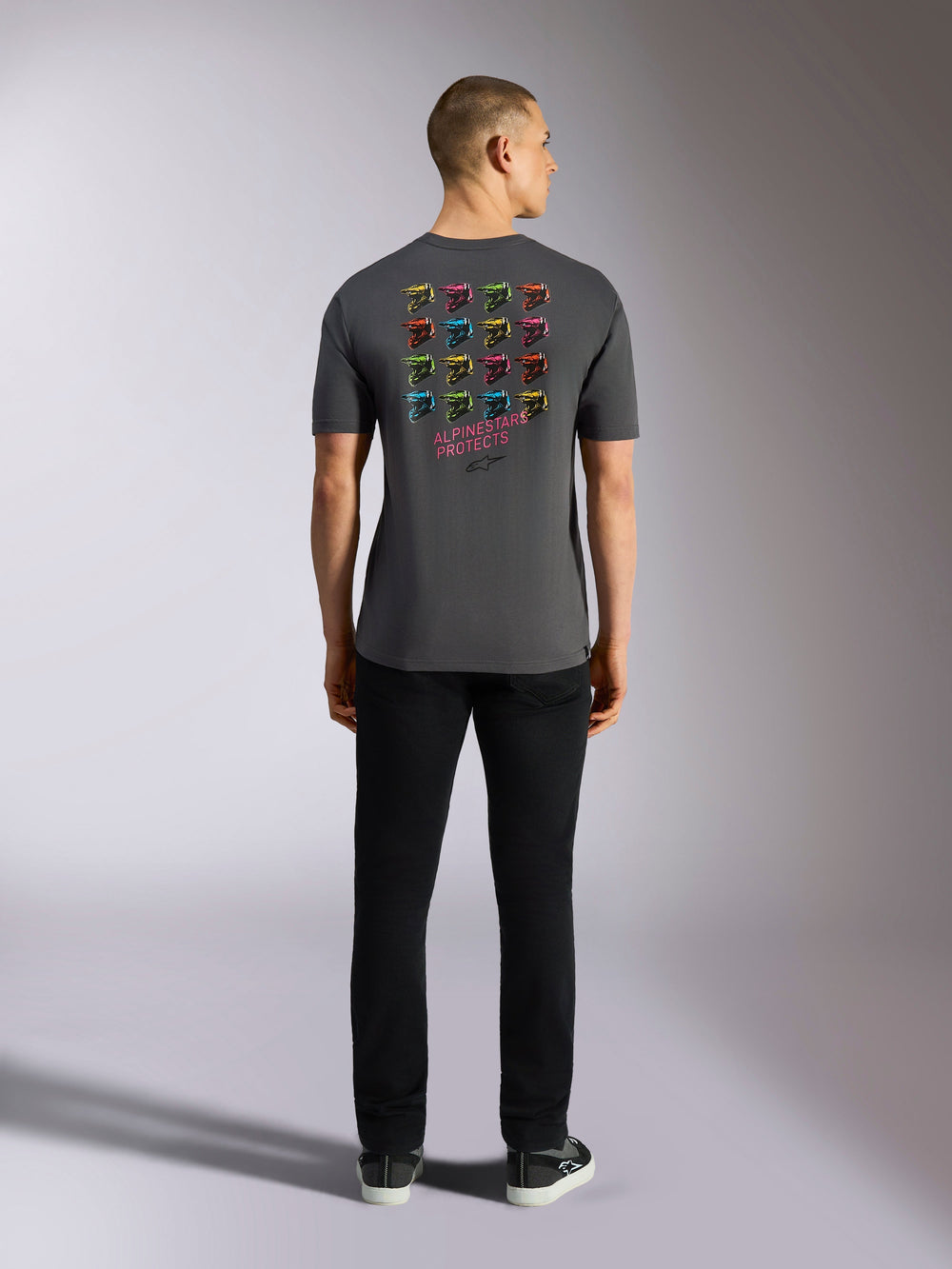 Alpinestars Pop Helmet CSF Tee, Short Sleeve T-Shirt, Charcoal Gray, featuring a grid of multi-colored M10 helmet graphics on the back with 'ALPINESTARS PROTECTS' text, Casual Motorsport Streetwear