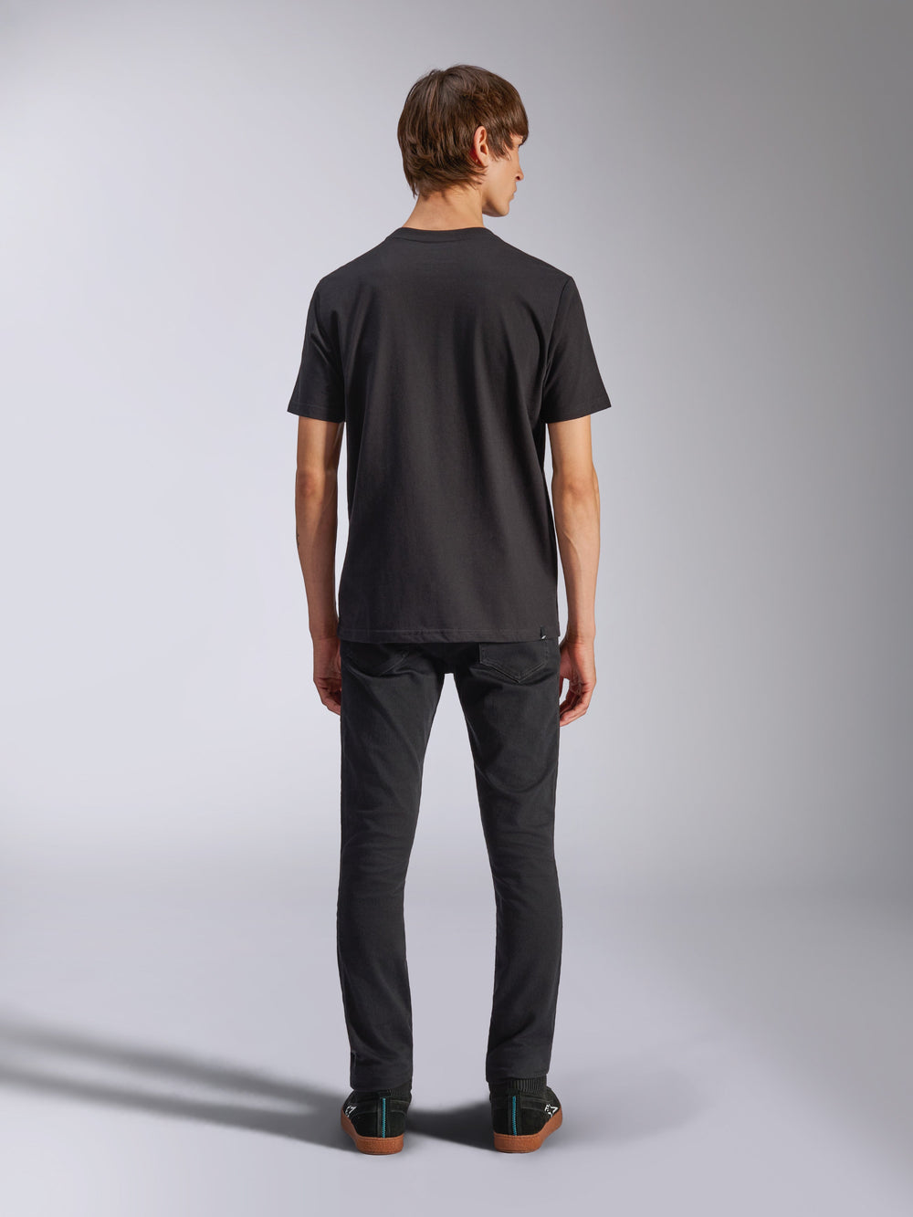 Alpinestars Harken CSF Tee, Short Sleeve T-Shirt, Black, back view showing fit, worn with black slim-fit pants and sneakers, casual motorsport-inspired lifestyle apparel