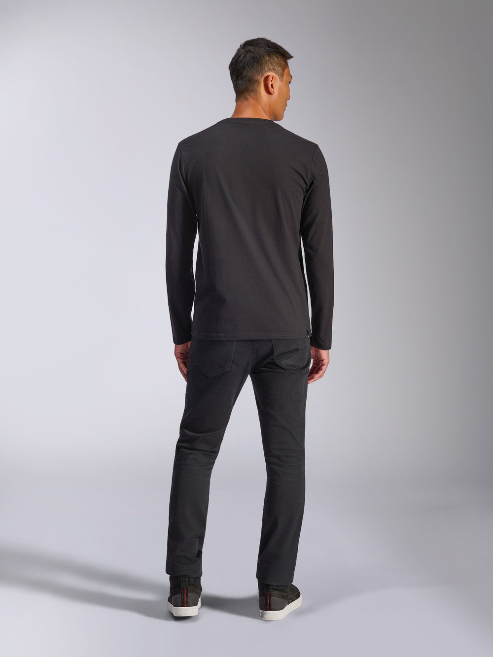 Alpinestars Trackside CSF Tee, Long Sleeve T-Shirt, Black, Back view of model wearing the shirt with dark pants, casual motorsport-inspired streetwear