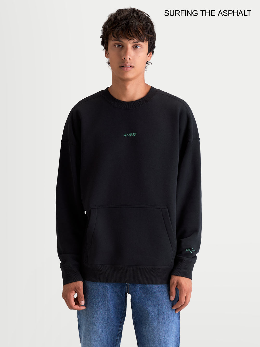 Alpinestars Guise Oversized Crew, men's sportswear fleece pullover in black, featuring a relaxed fit, crew neck, front kangaroo pocket, and embroidered logo worn by a model.