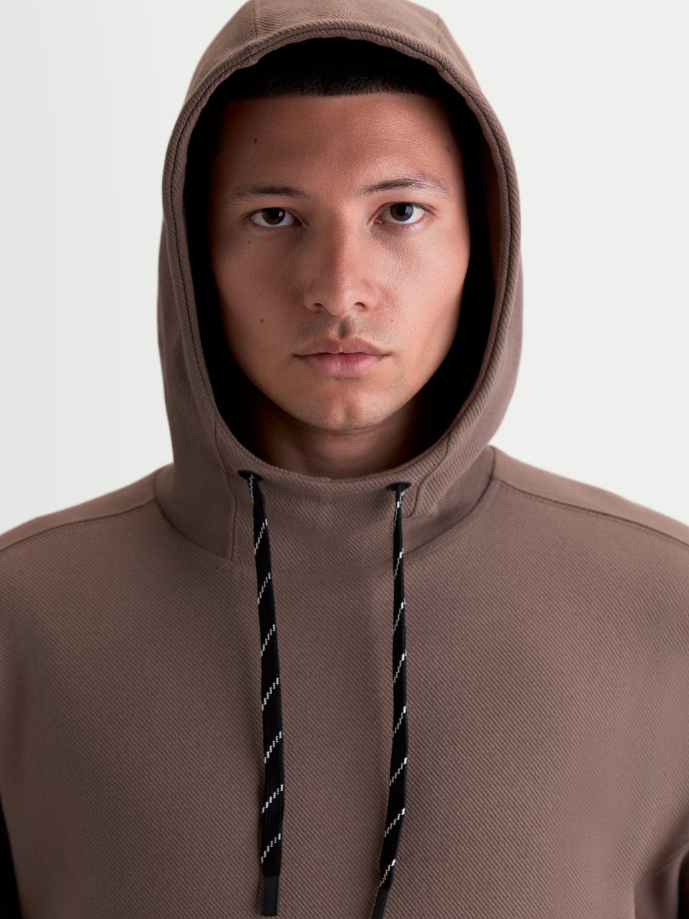 Alpinestars Camino Textured Oversized Hoodie, Casual Sportswear Pullover, Men and Women, Brown Taupe, Textured Knit Twill Fleece with High Collar and Two-Tone Drawcords, Close-Up View on Model