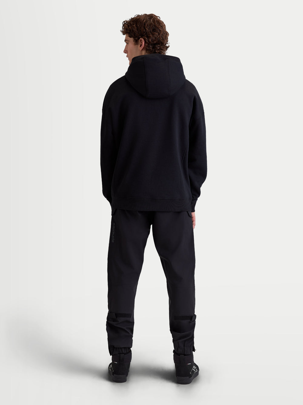 Alpinestars Shaw Oversized Hoodie, Black Casual Sportswear Pullover, Full-Length Back View on Model, Relaxed Silhouette with Self-Lined Hood and Ribbed Trims, Soft Fleece Construction.