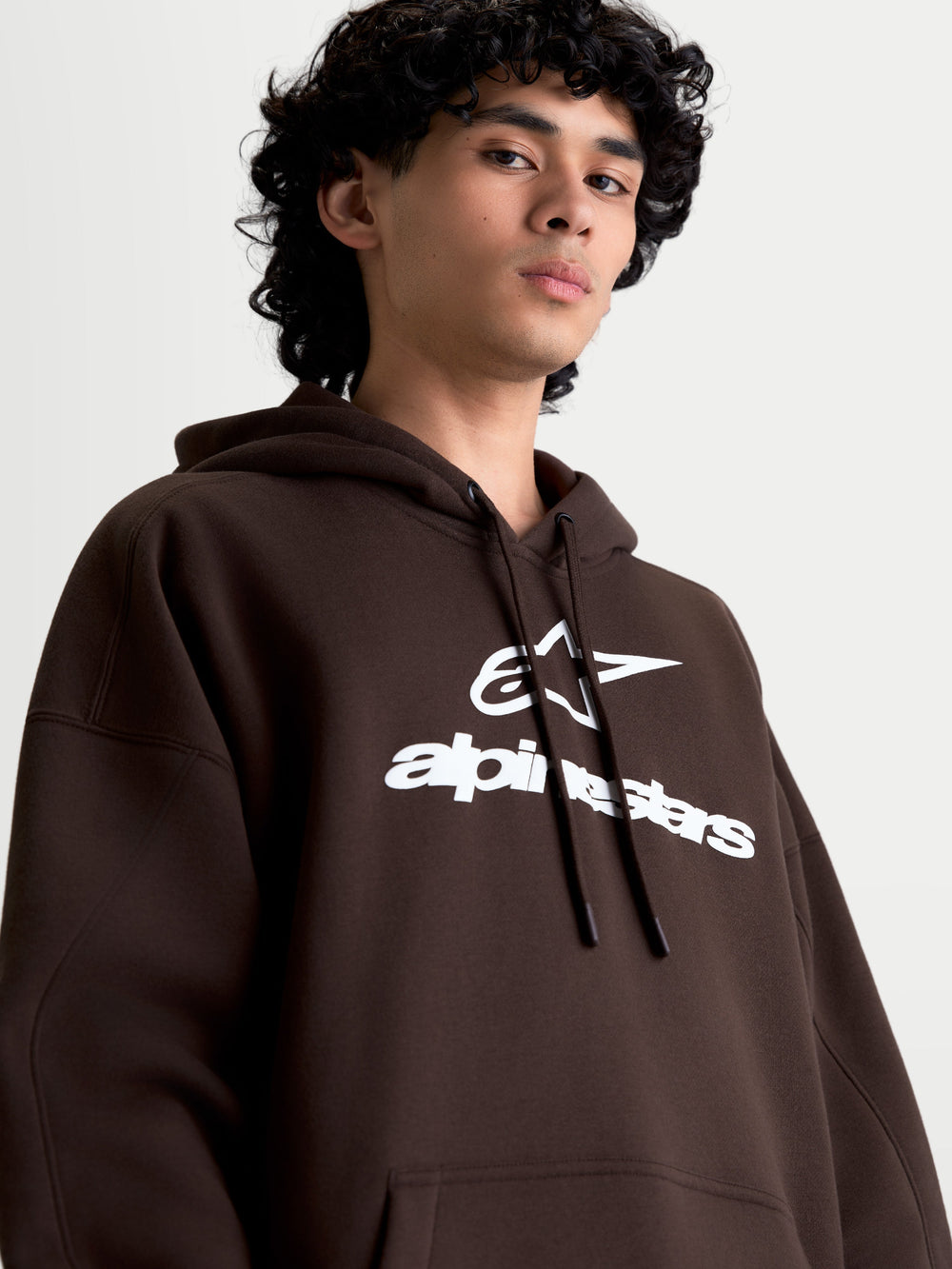 Alpinestars Prelude Oversized Hoodie, Brown Sportswear Fleece Pullover for Men and Women, featuring a white puff-print logo, relaxed fit, and self-lined hood with drawstrings.