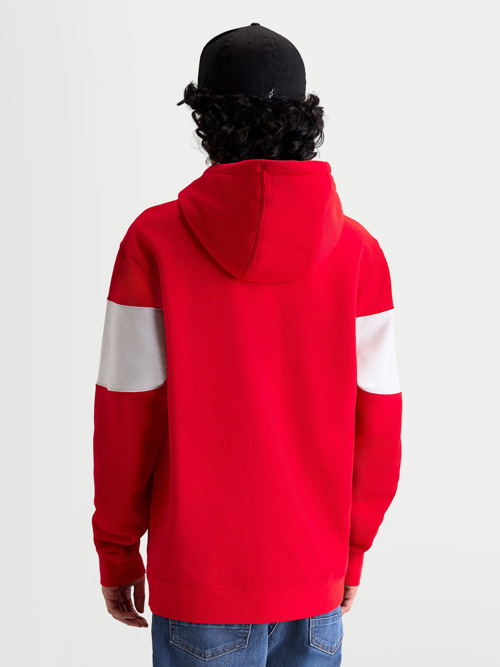 Alpinestars Cubic Hoodie, Sportswear Pullover Fleece, Red and White, Back View on Model wearing a black cap, featuring color-blocked sleeves, a self-lined hood, and ribbed cuffs for a motorsport-inspired look.
