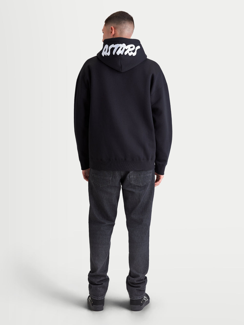 Alpinestars Pioneer Oversized Hoodie, Casual Sportswear Zip Fleece in Black, back view featuring white Astars embroidery on the hood, oversized fit, comfortable cotton-blend fabric for everyday lifestyle wear.