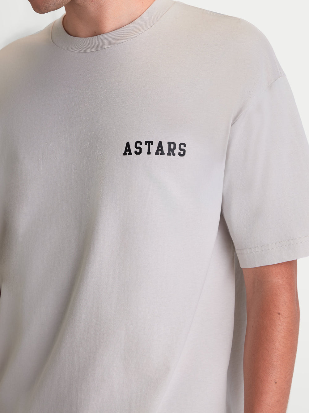 Alpinestars Latitude Oversized CSF Tee, Short Sleeve Sportswear T-Shirt, Cement Gray with Black ASTARS chest wordmark, Casual Relaxed Fit, soft 60/40 cotton-poly blend, seen on model.