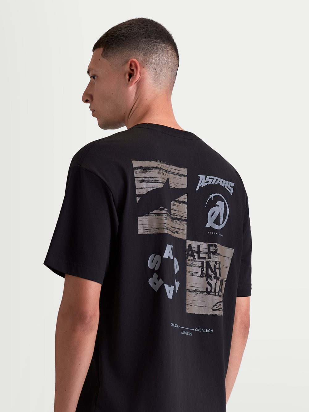 Alpinestars Checkback Oversized CSF Tee, Sportswear Short Sleeve T-Shirt, Black with a bold grey and white collage-style back graphic featuring the Astars logo, relaxed oversized fit.