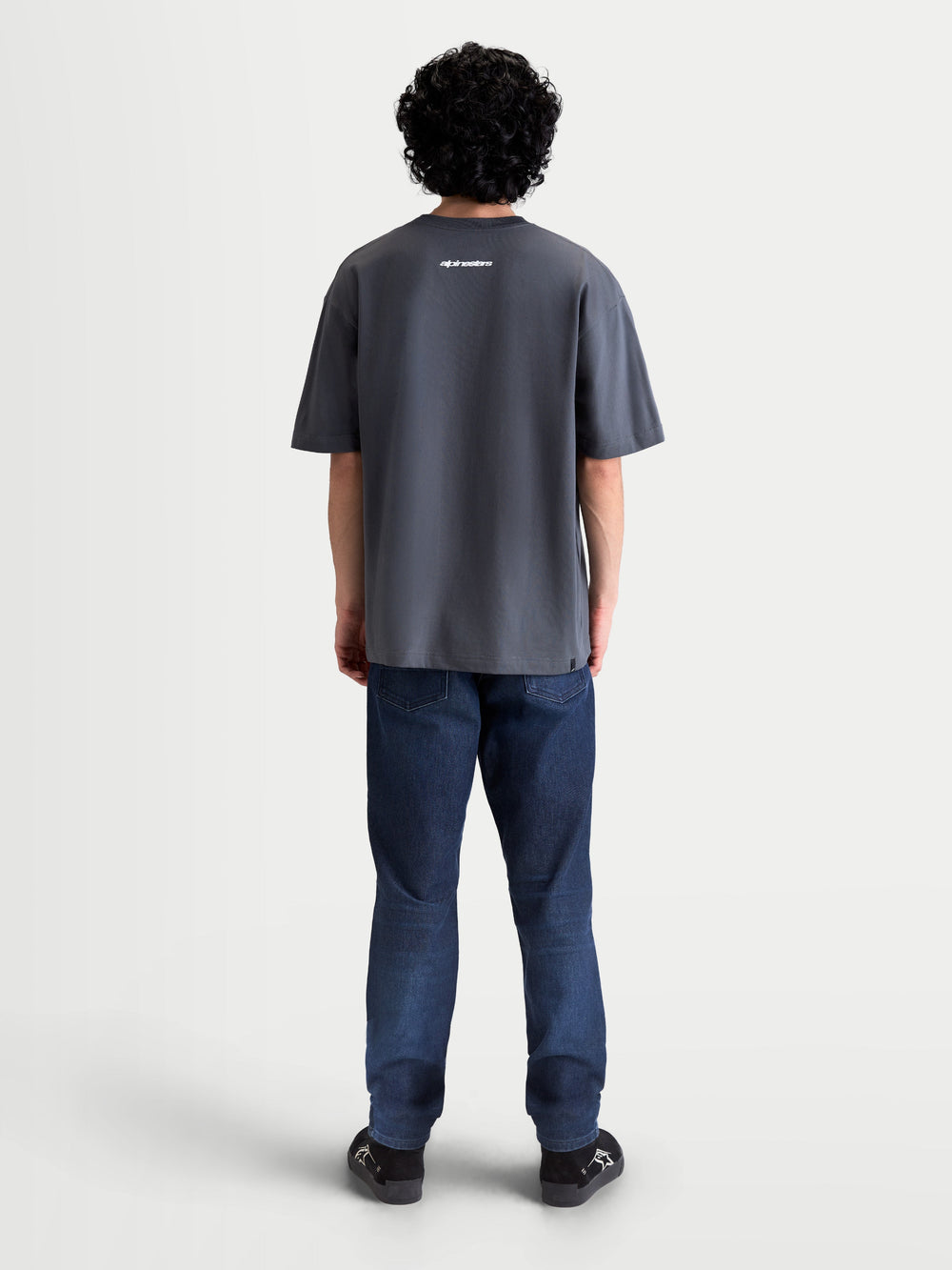 Alpinestars Mandate Oversized CSF Tee, Short Sleeve Sportswear T-Shirt, Unisex, Gray, cotton-poly blend, back view on model showing white Alpinestars wordmark graphic and relaxed oversized fit silhouette.