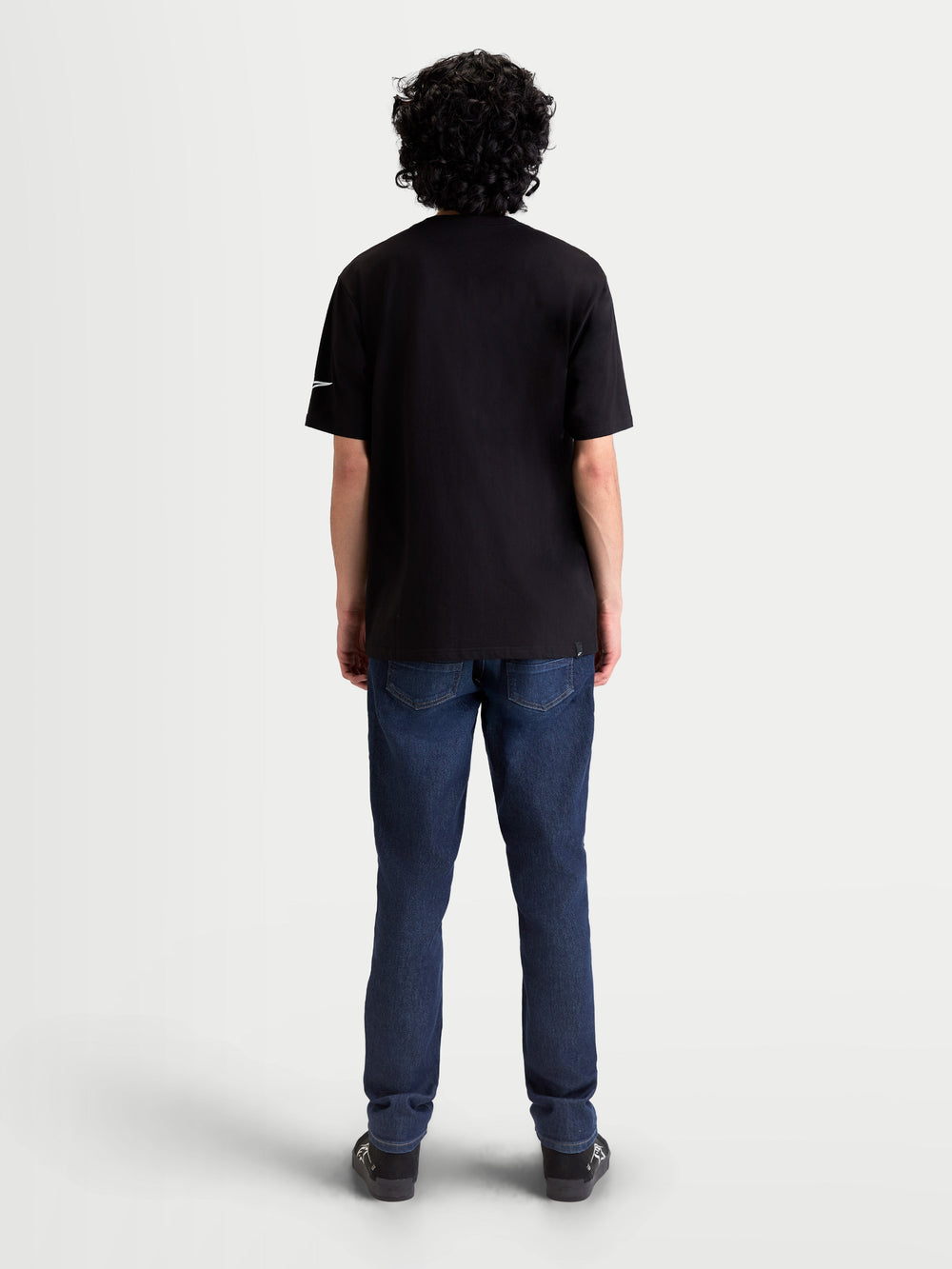 Alpinestars Race Wordmark CSF Tee, Black and White Short Sleeve Sportswear T-Shirt, Back View on Model, featuring the Ageless logo on the sleeve and a durable cotton-poly blend for everyday comfort.