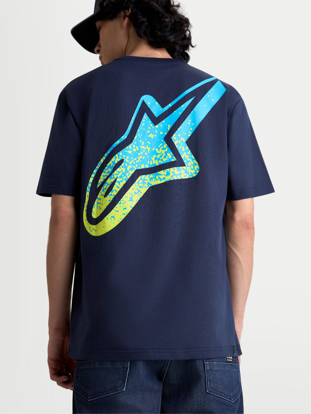 Alpinestars Meteor CSF Tee, Short Sleeve Sportswear Graphic T-shirt for Men and Women, Navy Blue with a large yellow and blue gradient Astars logo on the back, motorsport-inspired casual wear.