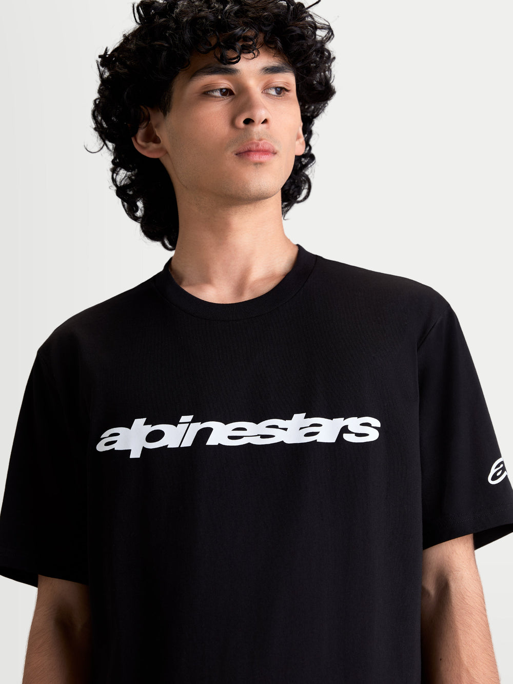 Alpinestars Race Wordmark CSF Tee, On-Model Casual Sportswear T-Shirt, Black and White, featuring a bold front wordmark graphic and sleeve Ageless logo, 60/40 cotton-poly blend for everyday comfort.