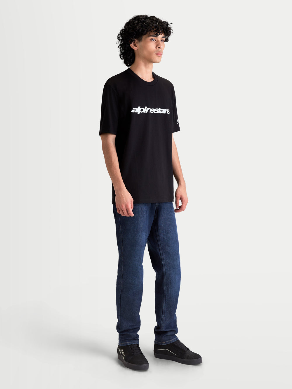 Alpinestars Race Wordmark CSF Tee, Casual Sportswear Short Sleeve T-Shirt for Men and Women, Black and White, featuring a white front wordmark logo and sleeve branding, on-model view, motorsport lifestyle apparel