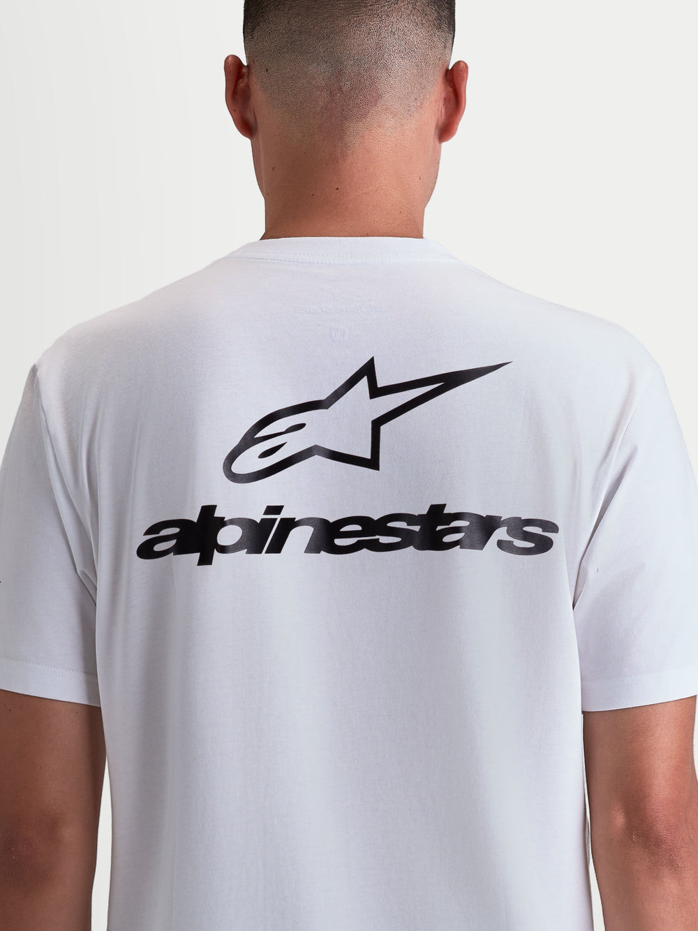 Alpinestars Combo Back CSF Tee, Short Sleeve Sportswear T-shirt, White and Black, back view on model featuring large black Alpinestars logo and wordmark graphic, premium cotton-poly blend.
