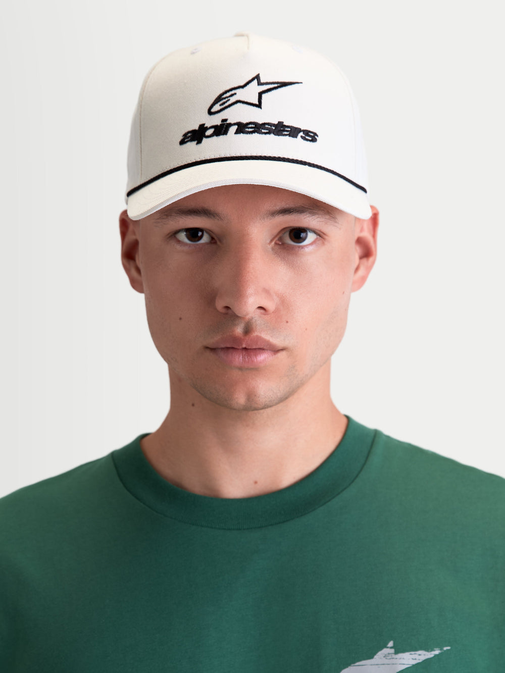Alpinestars Combo Logo Snapback Hat, Motorsport Lifestyle Sportswear Cap, Men and Women, Off White and Black, featuring Astars logo embroidery, curved bill, and structured crown, premium cotton twill, front view on model.