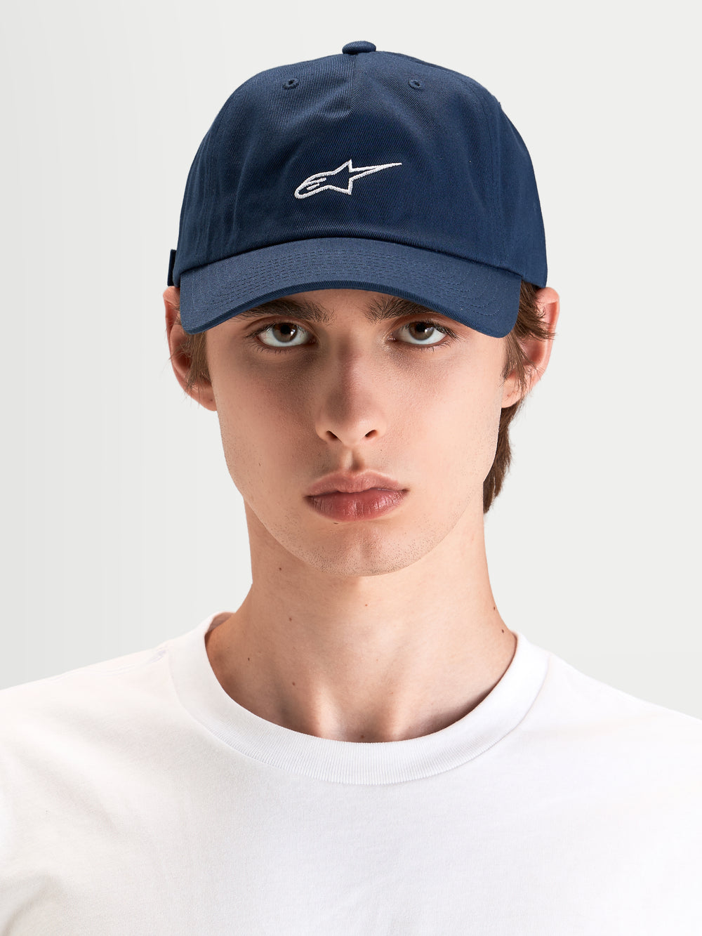 Alpinestars Dylan Dad Hat, casual sportswear cap in navy blue with white Astars logo embroidery, curved bill and unstructured low crown worn by a model