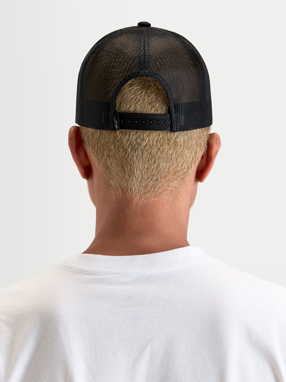 Alpinestars Hemmings Trucker Hat, sportswear snapback cap, Black, rear view showing breathable poly mesh back and adjustable snapback closure