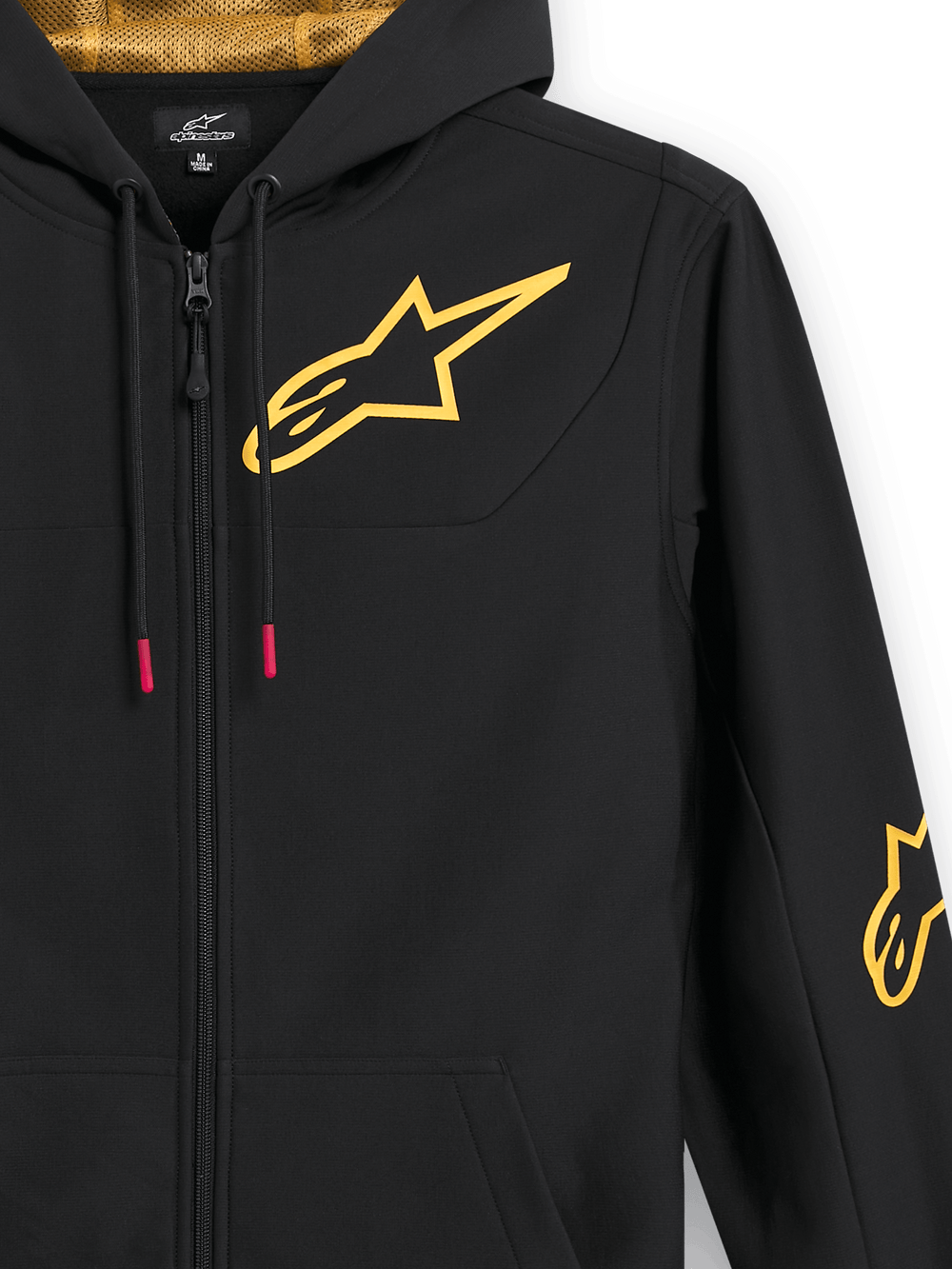 Alpinestars Sessions V3 Hoodie, black zip-up fleece, close-up showing large gold chest logo, gold mesh-lined hood, tech drawcords with red accents, casual motorsport-inspired streetwear
