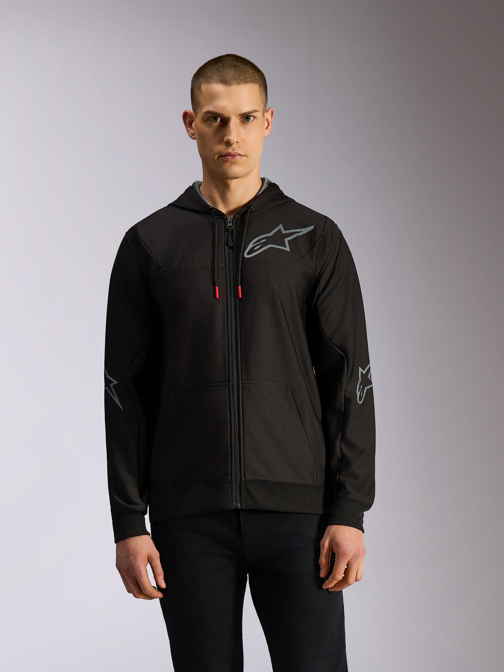 Alpinestars Sessions V3 Hoodie, zip-front poly fleece hoodie in Black and Grey, featuring grey star logos on the chest and elbows, tech drawcords with red tips, casual motorsport streetwear style.