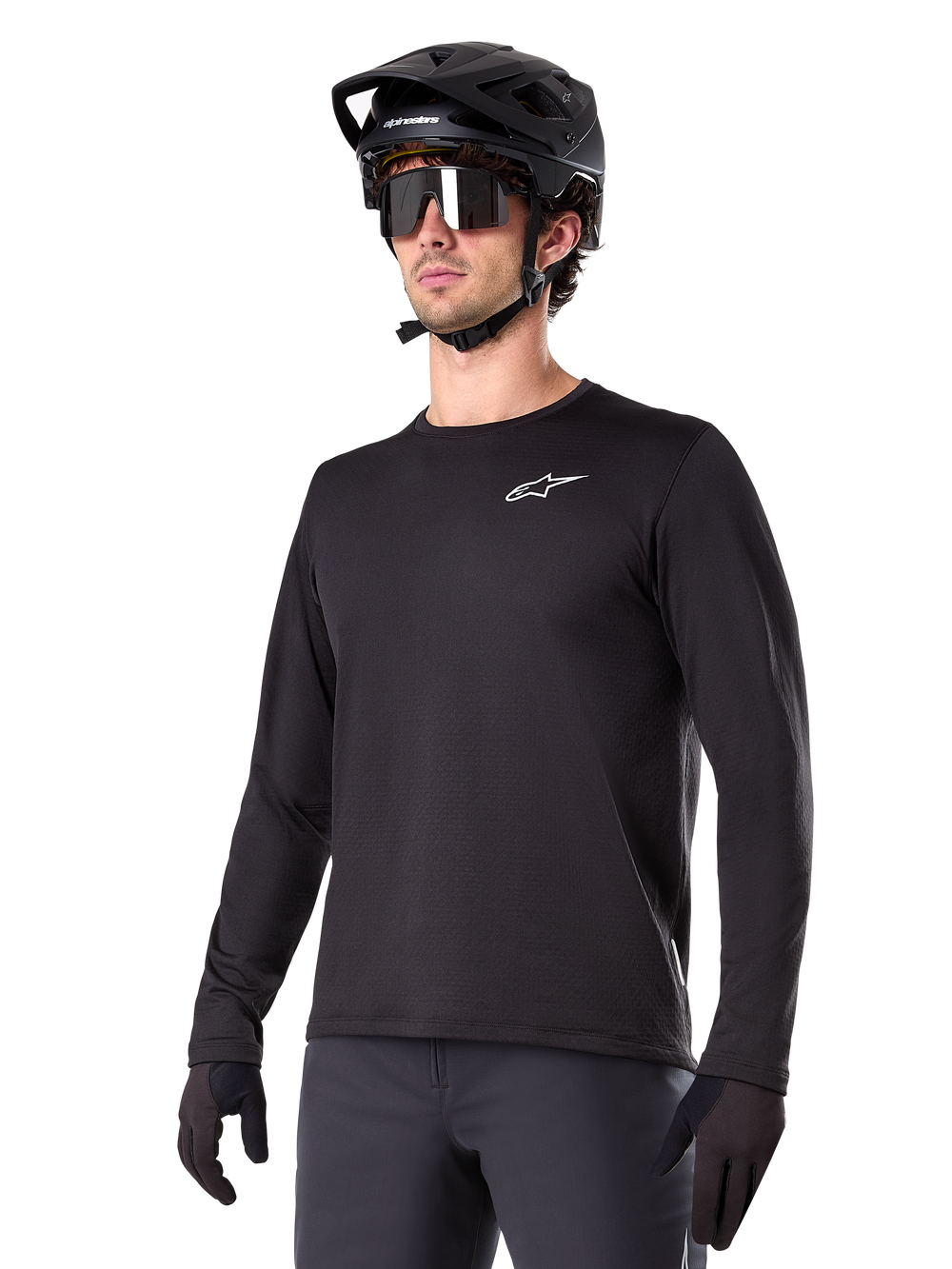 Alpinestars A-Dura Thermal Jersey, Black long-sleeve mountain bike jersey, white chest logo, worn with black helmet and gloves, sleek sporty design for trail riding