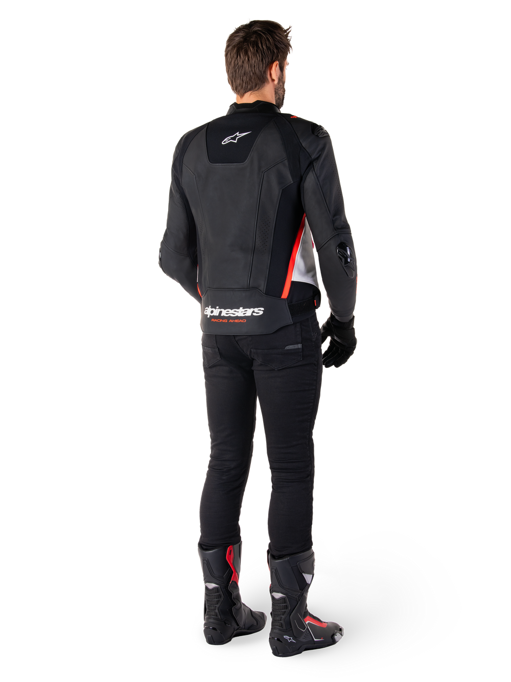 Alpinestars Missile V3 Leather Jacket in Black White Red Fluo, back view on a male rider, featuring Alpinestars branding on the upper and lower back, paired with black pants and motorcycle boots, racing-inspired leather sport jacket.