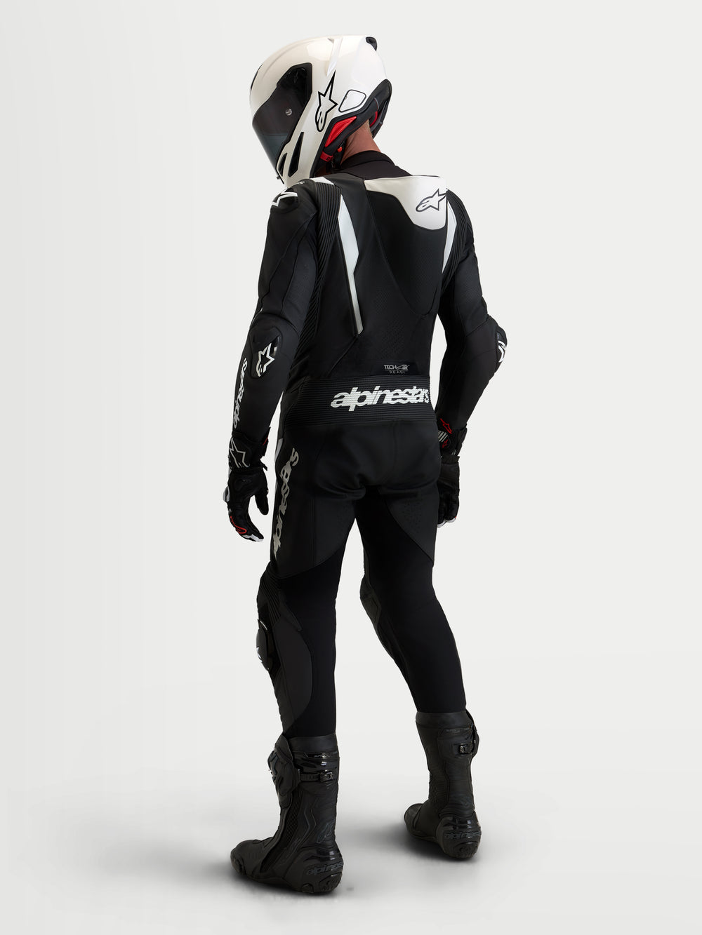 Alpinestars Missile V3 Leather Suit - 1 Piece, men's black and white motorcycle racing leather suit, AAA-rated track-focused design featuring DFS armor and aerodynamic speed hump, shown worn on a rider with a matching helmet