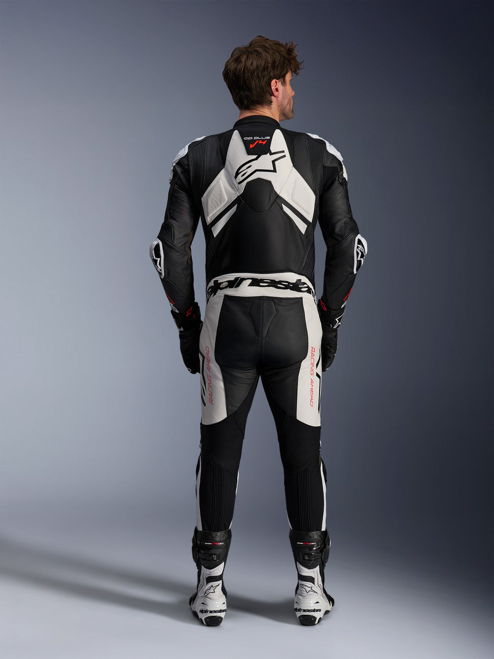 Alpinestars GP Plus V4 Sprint 1 Piece Leather Suit, Men's Racing Gear in Black and White with Red Fluo and aerodynamic hump.