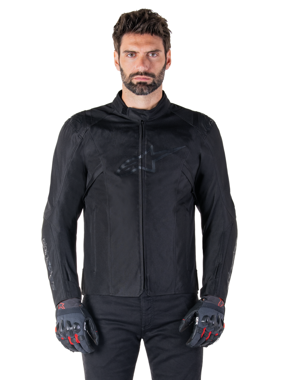 Alpinestars T-SPS V2 Waterproof Jacket, Black motorcycle textile jacket, worn by rider with black and red gloves, featuring a high collar, zippered front, and subtle chest logo, waterproof protection for sport and urban riding