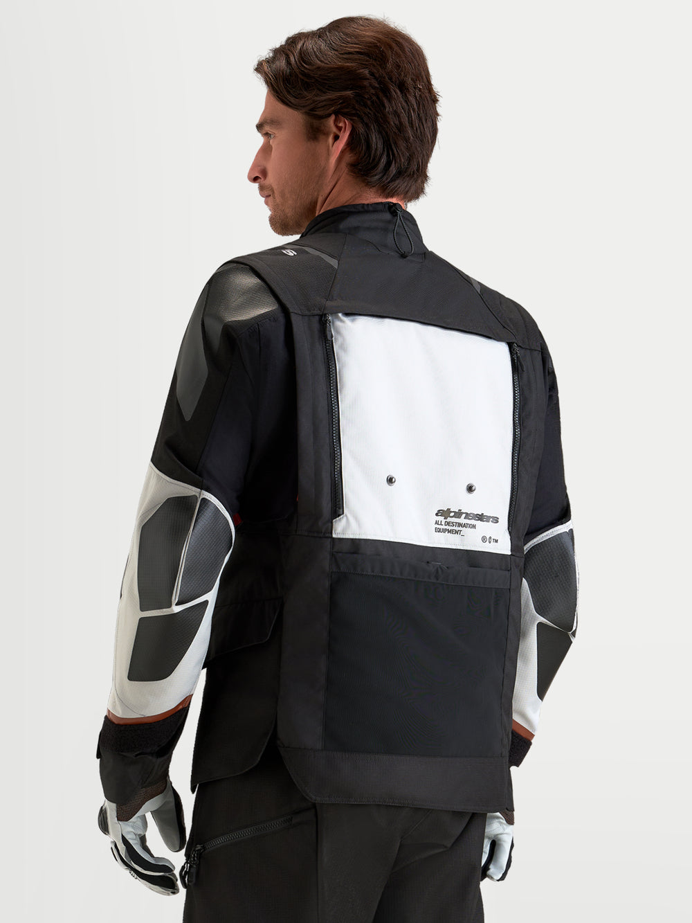Alpinestars Harok V2 Drystar Jacket, Men's adventure motorcycle jacket in dark gray, ice gray, and black, featuring a modular ventilation system with foldable back panel, CE-certified protection, and recycled ripstop textile construction, shown from the back on a model