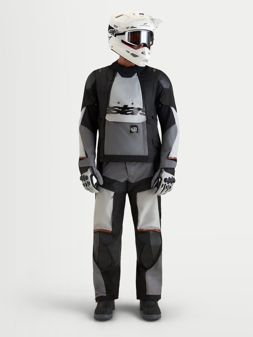 Alpinestars Harok V2 Drystar® Jacket, men's all-terrain adventure motorcycle textile jacket in dark gray, ice gray, and black, front view worn by a model wearing a matching helmet and gear, AA certified waterproof adventure riding apparel.