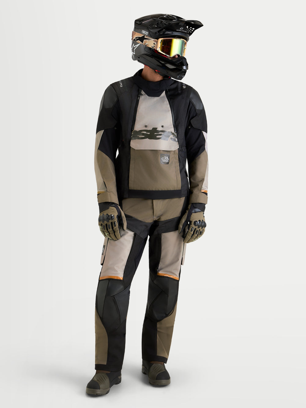 Alpinestars Harok V2 Drystar Jacket, Men's Adventure Motorcycle Jacket, Aluminum, Walnut, and Black, worn with matching riding pants, helmet, goggles, and gloves for all-terrain touring