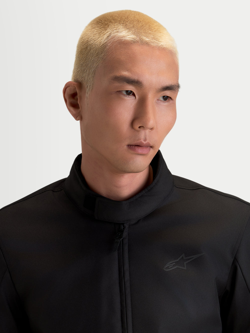 Alpinestars C-1 Waterproof Jacket, men's urban contemporary motorcycle textile jacket in black, close-up view showing the soft-finish collar and polyfabric construction worn by a model.