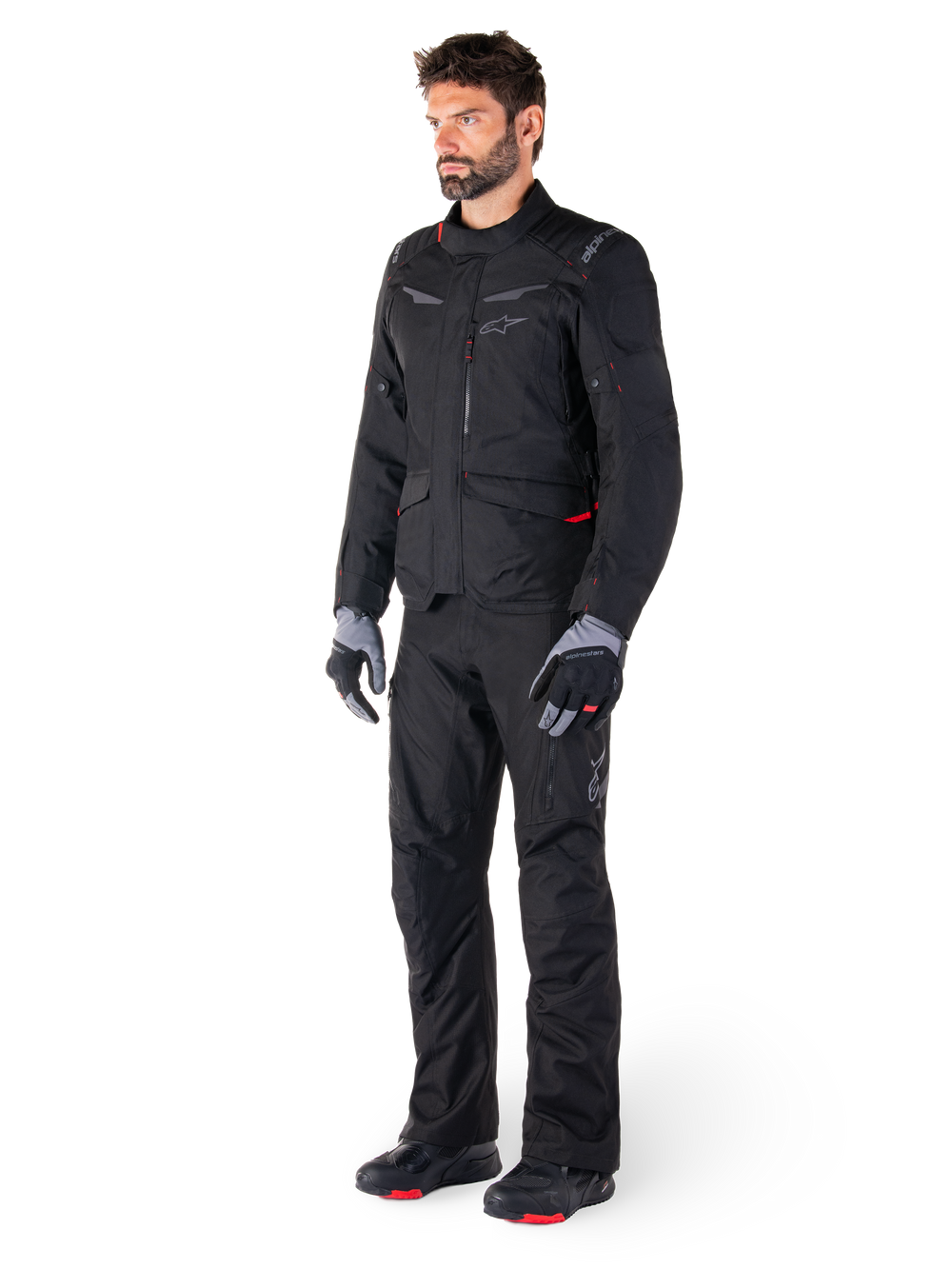 Alpinestars ST-1 Waterproof Jacket, Black, adventure touring jacket with red accents, worn with matching black pants, gloves and boots, full body view of rider in complete all-weather gear set