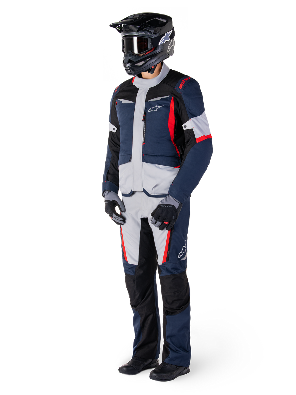 Alpinestars ST-1 Waterproof Jacket, Adventure Touring Jacket, Dark Blue Black and Bright Red, worn by a rider with matching pants, black adventure helmet, gloves, and boots, featuring grey panels and red accents, streamlined adventure-inspired design with Alpinestars logos
