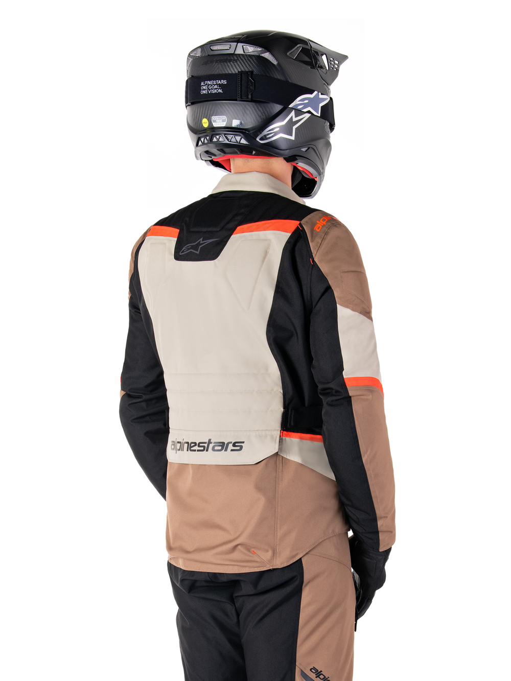 Alpinestars ST-1 Waterproof Jacket, Adventure Touring Jacket, Dark Khaki Sand Black Red Fluo, Back view showing color-blocked textile panels, fluorescent red accents, and Alpinestars branding on the lower back, worn by a rider with a black helmet.