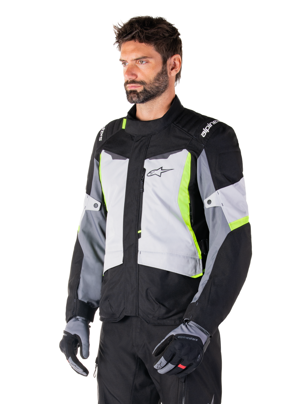 Alpinestars ST-1 Waterproof Jacket, Ice Gray Black Yellow Fluo, worn by a man with matching gloves and black pants, featuring gray torso panels with fluorescent yellow accents, black shoulders with white branding, adventure touring design for road riding