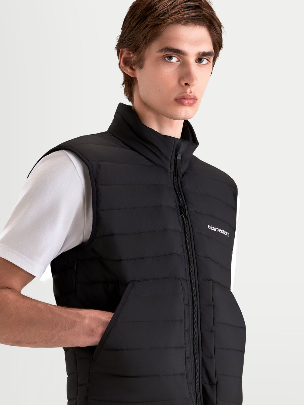 Alpinestars C-7 Drystar XF Jacket, men's urban contemporary motorcycle jacket worn as a black insulated vest with a white t-shirt underneath, close-up view showing the Primaloft detachable thermal vest and warm collar