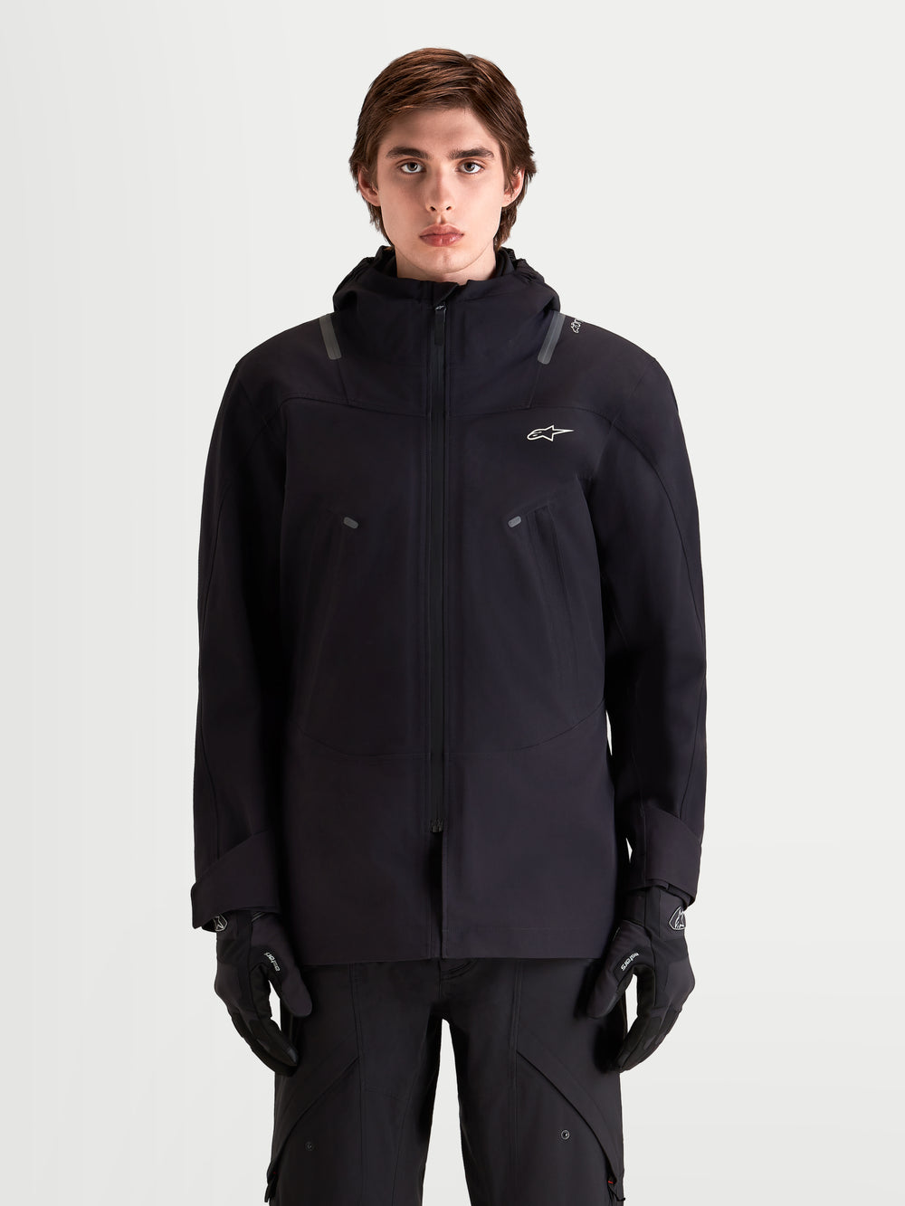 Alpinestars C-7 Drystar®XF Jacket, men's urban contemporary motorcycle textile jacket in black, front view on a model wearing matching gloves and riding gear, waterproof and breathable all-weather design with integrated hood.