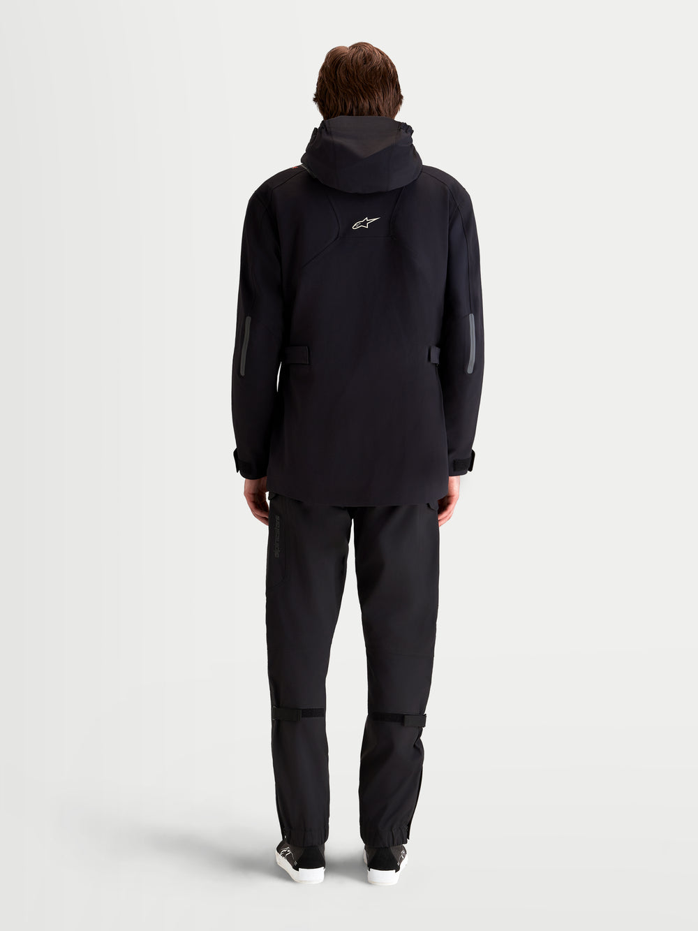 Alpinestars C-7 Drystar®XF Jacket, men's urban contemporary motorcycle textile jacket in black, rear view on a model showing extended-length chassis, integrated hood, and reflective details for waterproof all-weather commuting.