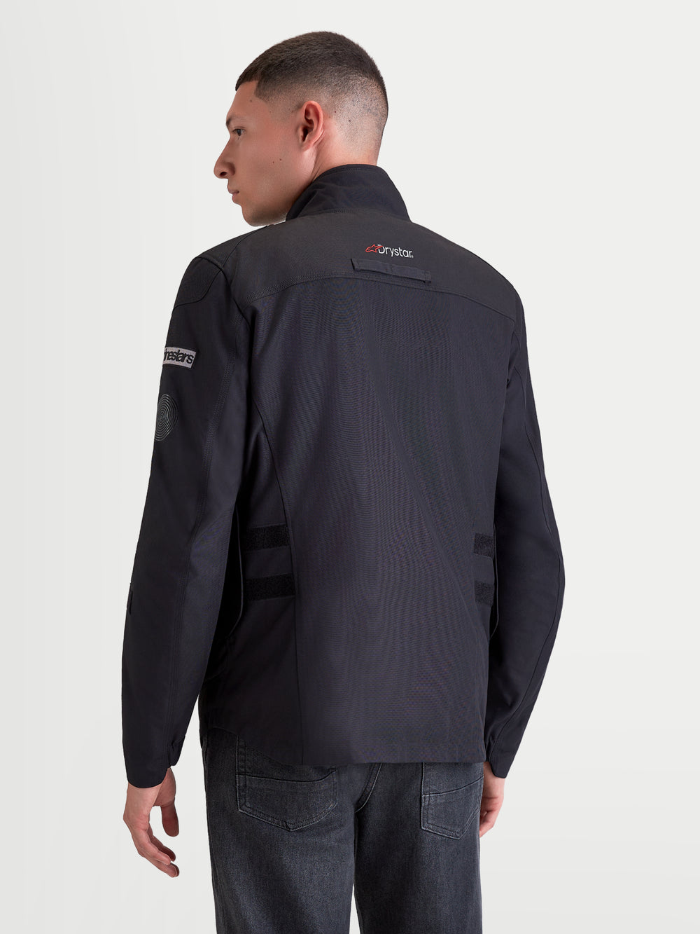 Alpinestars Altan Drystar Jacket, men's urban contemporary motorcycle textile jacket in black, rear profile view on a model wearing the waterproof riding jacket with Drystar technology and integrated warm collar
