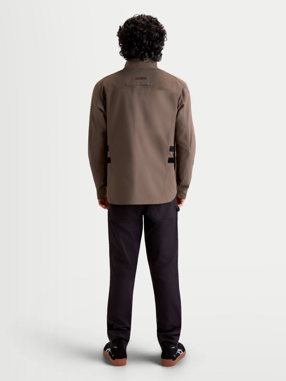 Alpinestars Altan Drystar Jacket, men's urban contemporary motorcycle textile jacket in walnut and black, rear profile view on a model showing the waterproof field-jacket construction and high collar.