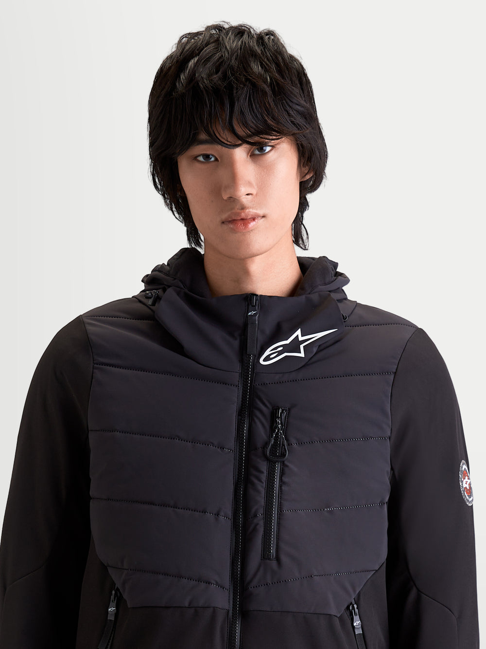 Alpinestars Therma-Tech Waterproof Jacket, men's urban contemporary motorcycle jacket in black, front view on a model showing sonic-welded down construction and integrated hood system.