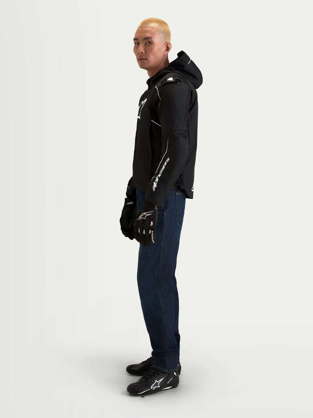 Alpinestars Zaca V2 Waterproof Jacket, Men's motorcycle waterproof textile jacket, Black and White, CE certified with Nucleon armor, worn by a model in profile view