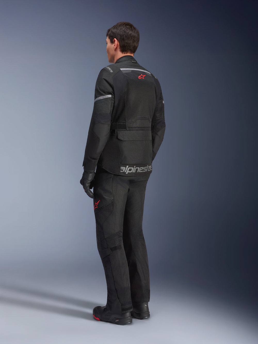 Alpinestars Andes Air Drystar® Pants and matching jacket, Black with red star logos, adventure touring motorcycle gear shown from the back, featuring mesh ventilation panels and reflective details.