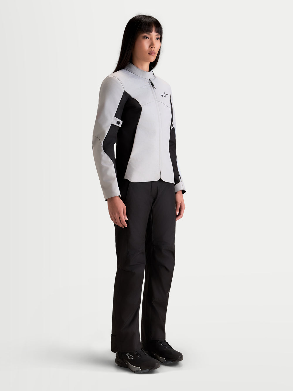 Alpinestars Stella C-1 Waterproof Jacket, women's urban motorcycle textile jacket in ice gray and black, worn by a model showing the waterproof commuter fit and soft collar construction