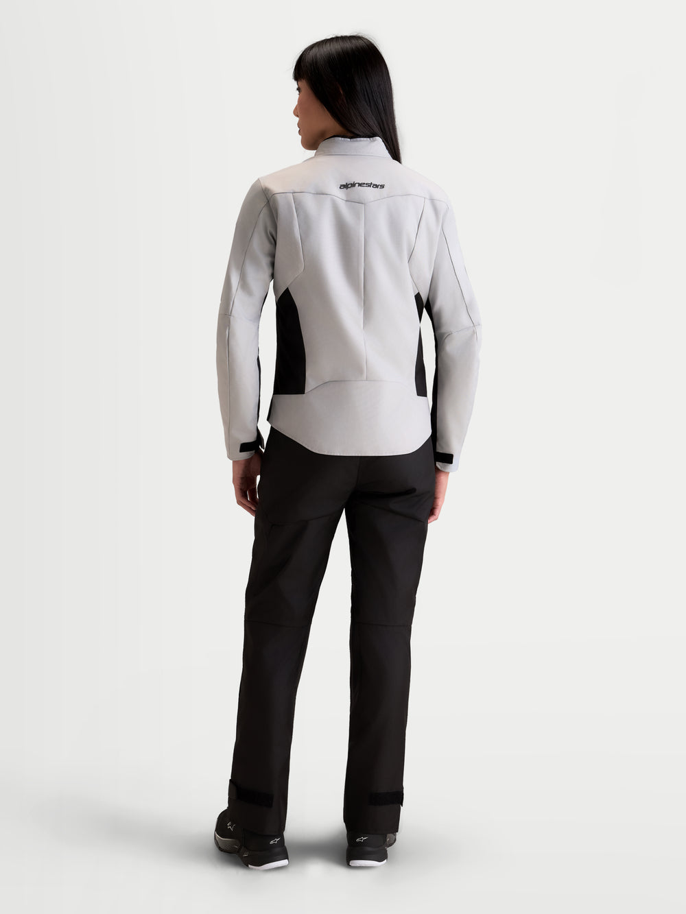 Alpinestars Stella C-1 Waterproof Jacket, women's urban motorcycle textile jacket in ice gray and black, rear view on a model showing 3D back construction and waterproof textile design.