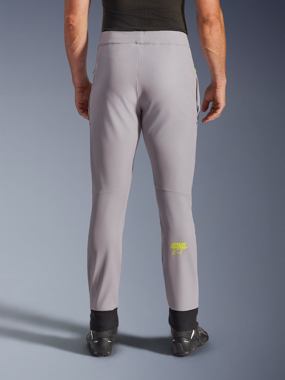 Alpinestars Aeroshell Pants, Motorcycle Pants, Mid Gray and Yellow Fluo, back view showing yellow Astars logo on the calf, black elastic ankle cuffs, modern softshell textile design for road and casual riding.