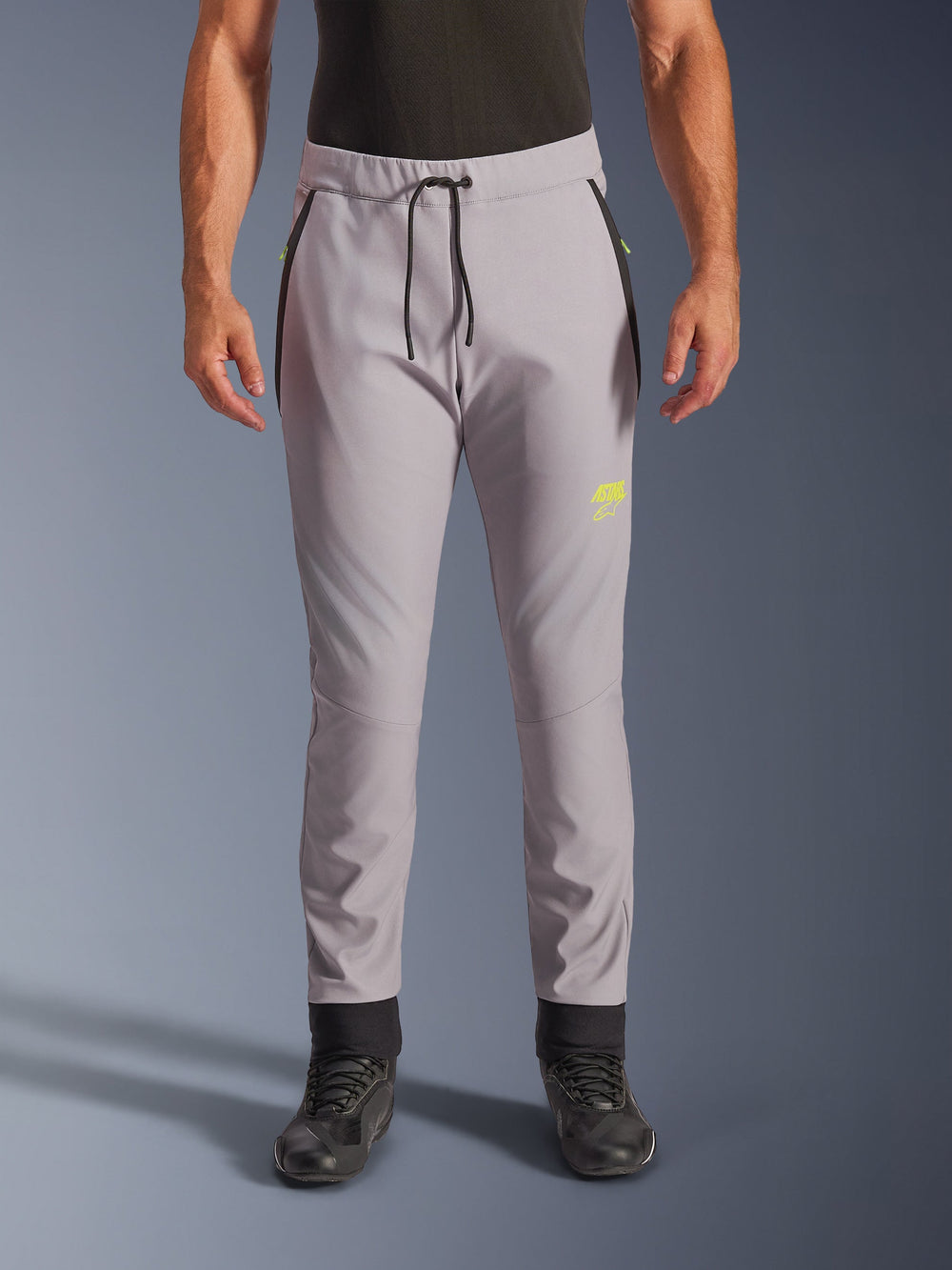 Alpinestars Aeroshell Pants, Mid Gray and Yellow Fluo, crossover softshell motorcycle pants, featuring a black drawstring waist and fitted ankle cuffs, yellow logo on left thigh, pre-curved knees, sporty jogger-style silhouette