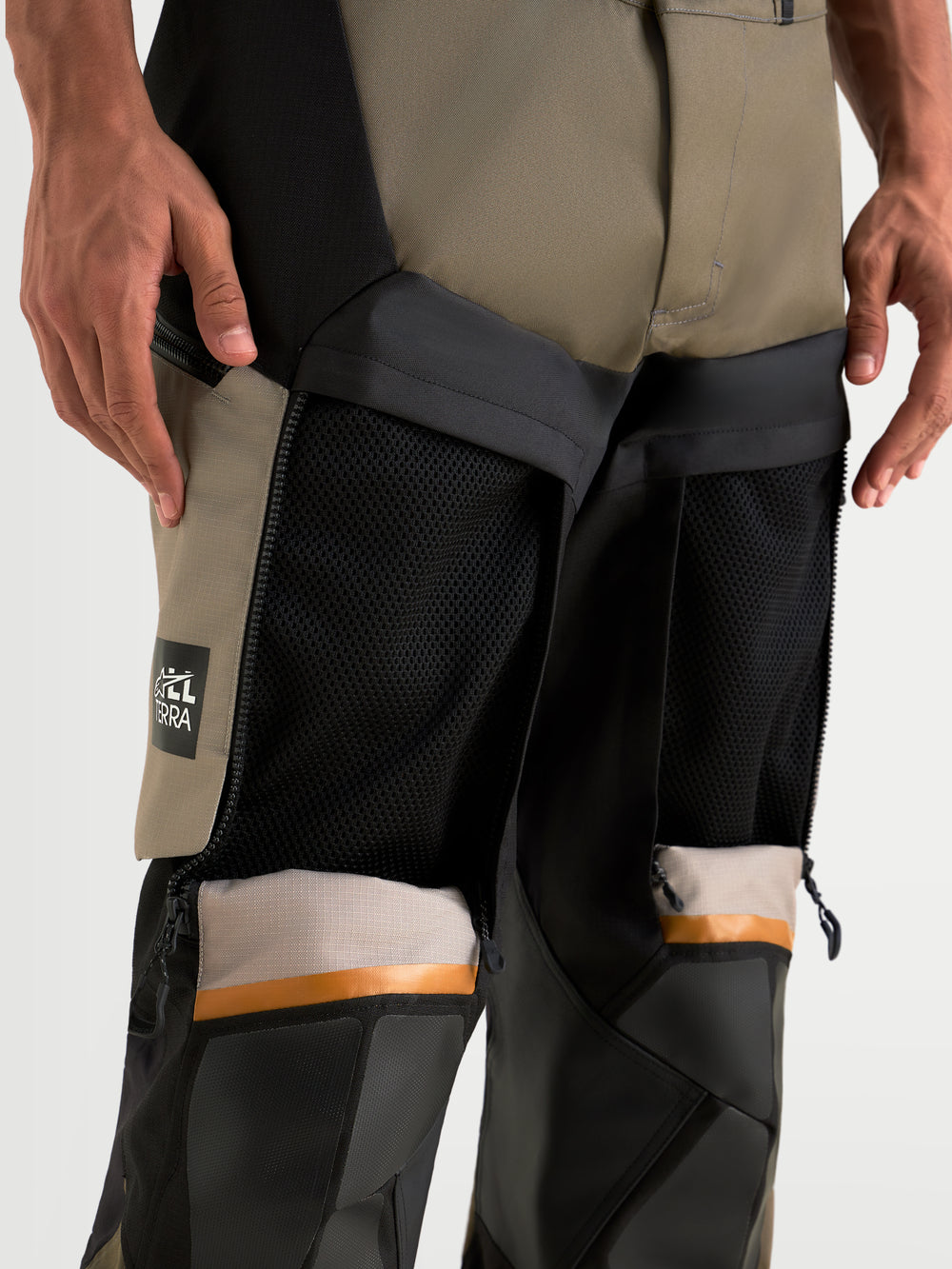 Alpinestars Harok V2 Drystar Pants, men's adventure touring motorcycle pants in aluminum, walnut, and black, close-up view showing open direct ventilation thigh panels and ripstop textile construction worn on a model